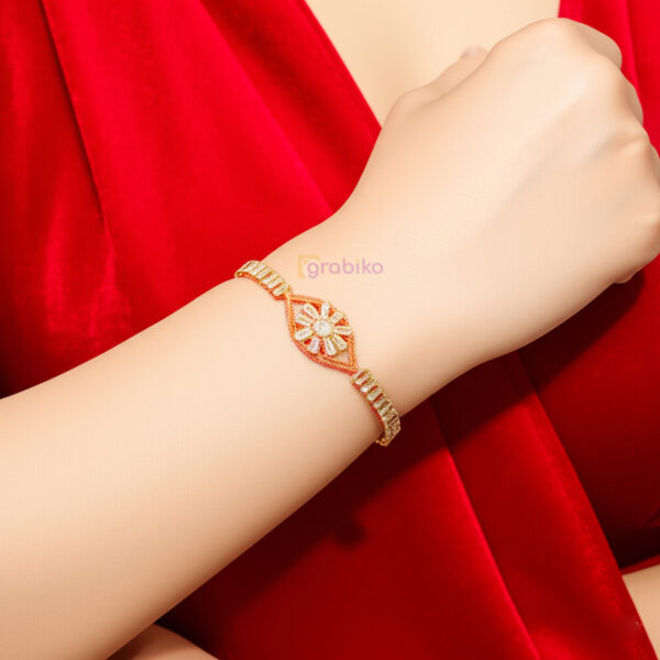 Gold-tone starburst bracelet for women with clear crystal baguettes on adjustable chain – stylish fashion jewelry by Grabiko.
