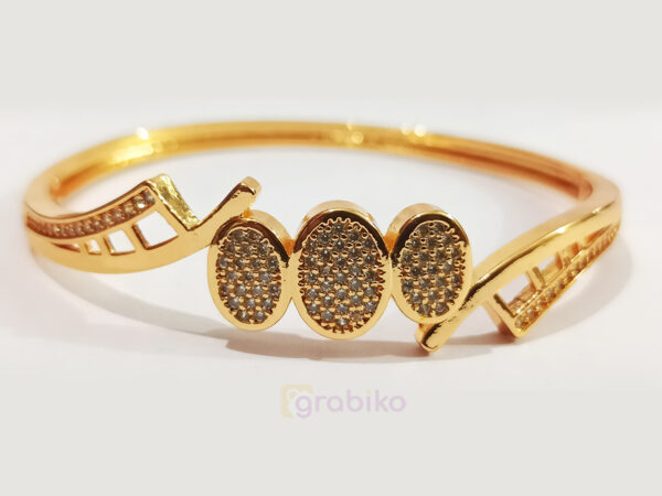 Elegant gold-plated bracelet with triple oval motif design, studded with sparkling stones