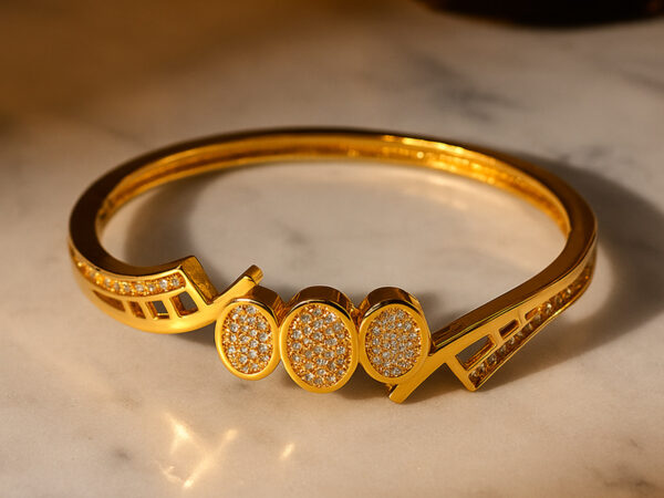 Elegant gold-plated bracelet with triple oval motif design, studded with sparkling stones