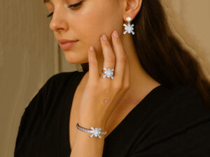 Silver snowflake jewelry set with earrings, bracelet, and ring adorned with cubic zirconia stones