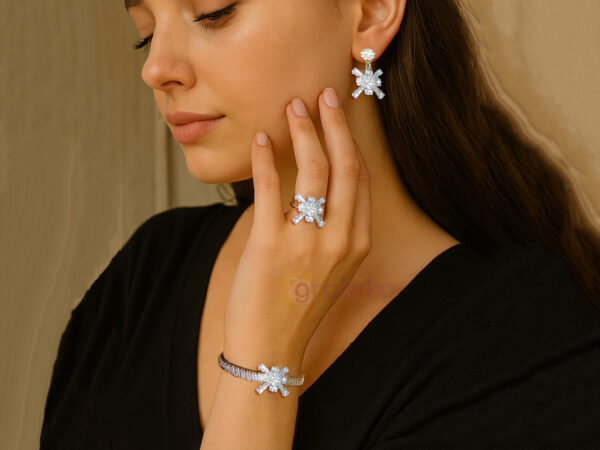 Silver snowflake jewelry set with earrings, bracelet, and ring adorned with cubic zirconia stones