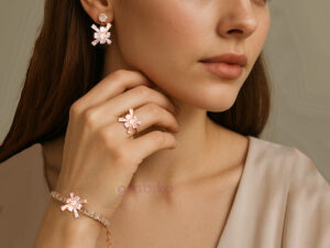 Rose gold jewelry set with snowflake design earrings, bracelet, and ring adorned with cubic zirconia stones