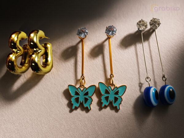 Trendy 3-pair earring combo for women with gold hoops, blue butterfly dangle earrings, and evil eye drops.