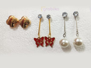 Elegant 3-pair earring combo with gold clover studs, red butterfly danglers, and pearl drop earrings.