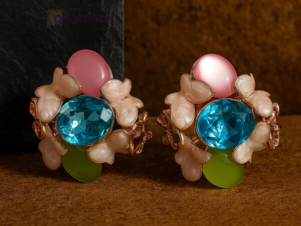 Vibrant floral earrings with blue crystal centerpiece and pink, green, and white accents