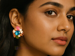 Vibrant floral earrings with blue crystal centerpiece and pink, green, and white accents