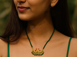 Elegant double peacock mangalsutra with CZ stones and green beads on pink fabric background