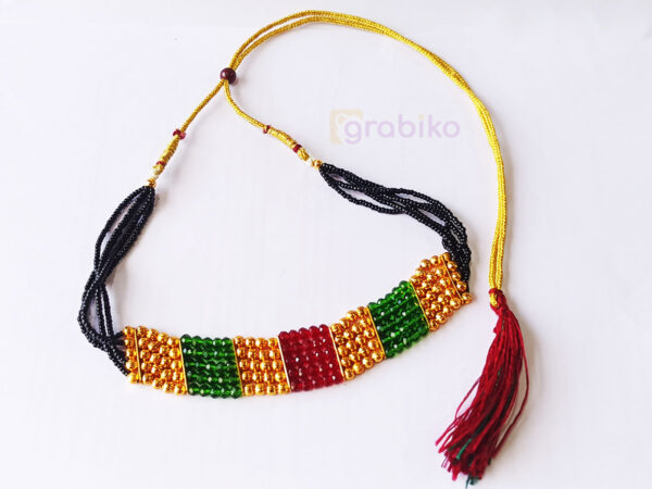 Traditional Indian mangalsutra necklace with black beads and colorful golden, green, and red patches