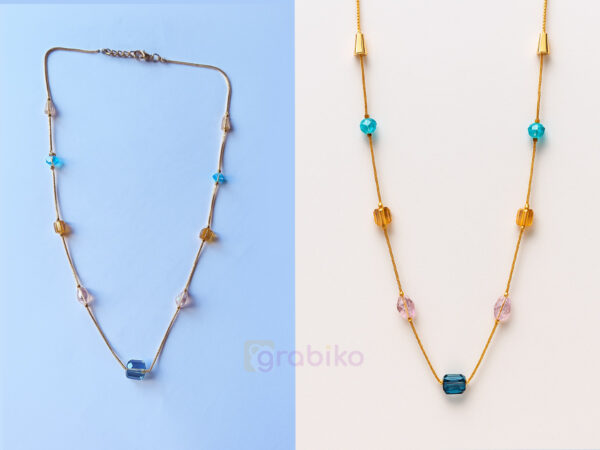 Elegant gold chain necklace with multicolor beads on a white background.