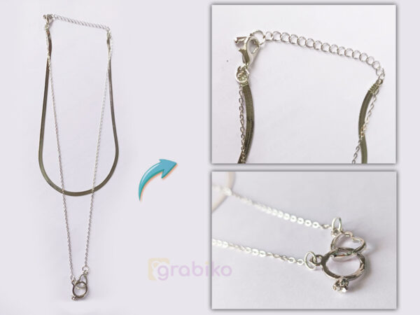 Silver-tone double-layer necklace with snake chain, link chain, and interlocking rings pendant featuring a crystal accent.